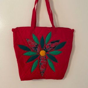 Red quilted tote bag with green floral design
